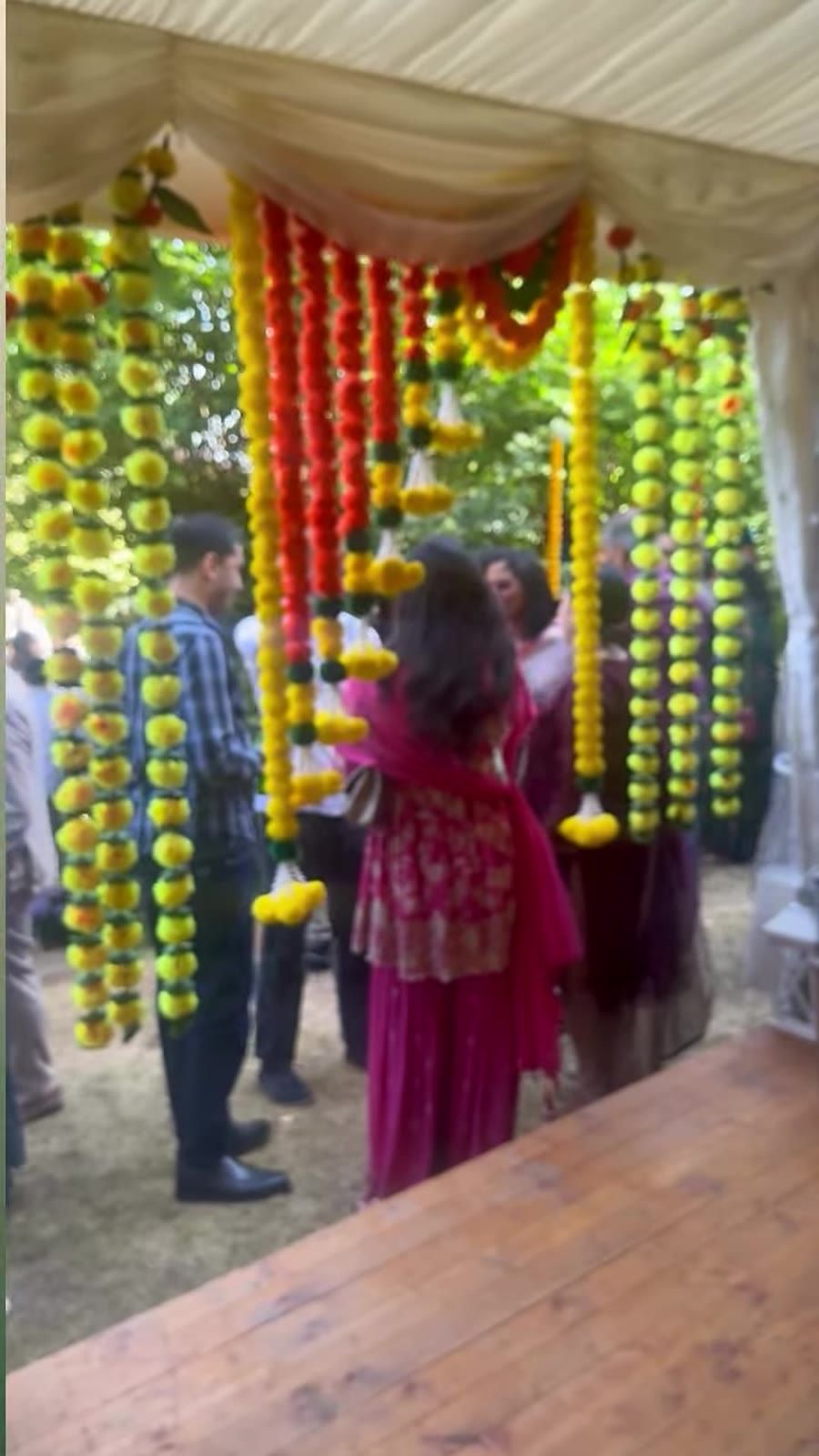 An engagement stage with a marigold flower arch